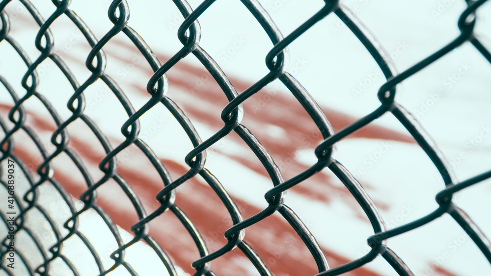 Fototapeta premium Metal chain-link fence with ice on it.