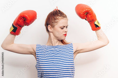 emotional woman in boxing gloves red lips striped jersey workout