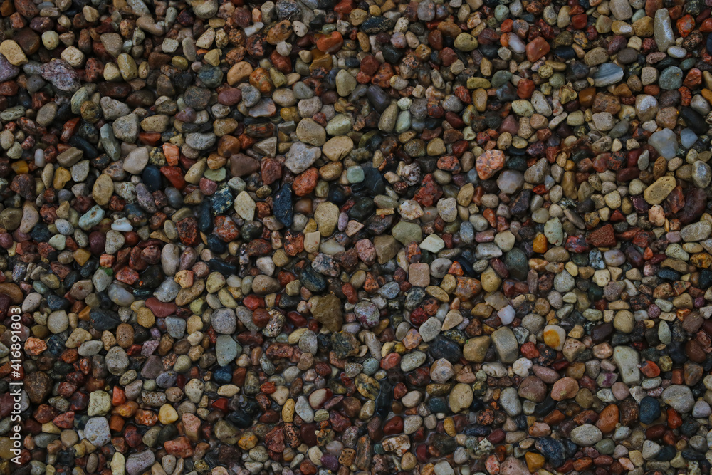 Multi colored stones on the beach. Background. Multi colored stones on the beach. Background.