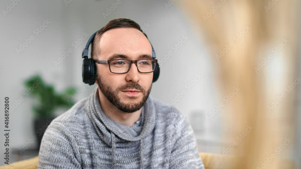 Cheerful man headphones enjoying rhythm audio sound dancing. Medium close up shot on 4k RED camera Cheerful man headphones enjoying rhythm audio sound dancing. Medium close up shot on 4k RED camera