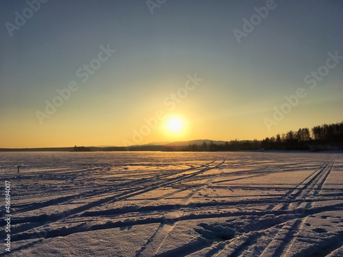 Sunset over frozen lake