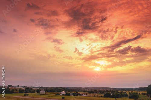 Blazing cloudy sky in the countryside at sunset. View from above