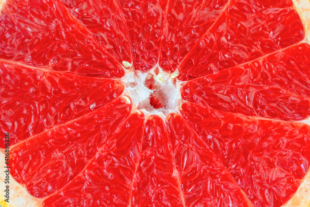 Red juicy grapefruit is cut in half macro shooting. Red juicy grapefruit is cut in half macro shooting.