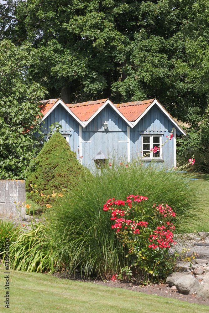 Garden with small blue huts in Tuno island, Denmark Garden with small blue huts in Tuno island, Denmark