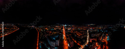 Panorama of night aerial view of the city of Ivano-Frankivsk, bright lights from cars and night lighting of the city.