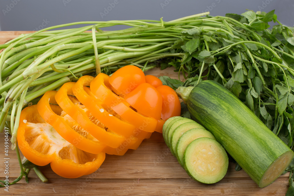 green water parsley and bell pepper and zucchini on wooden cutting board. green water parsley and bell pepper and zucchini on wooden cutting board.
