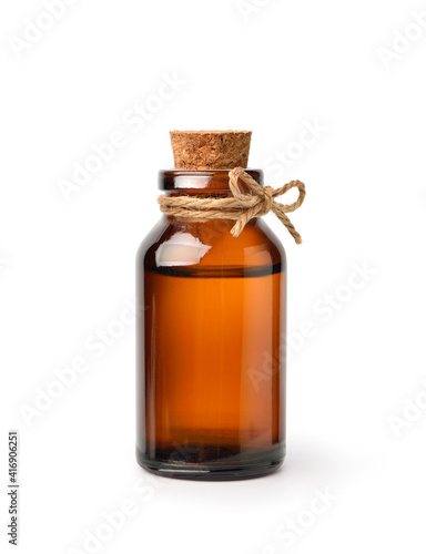 Essential oil extract in amber bottle isolated on white background.