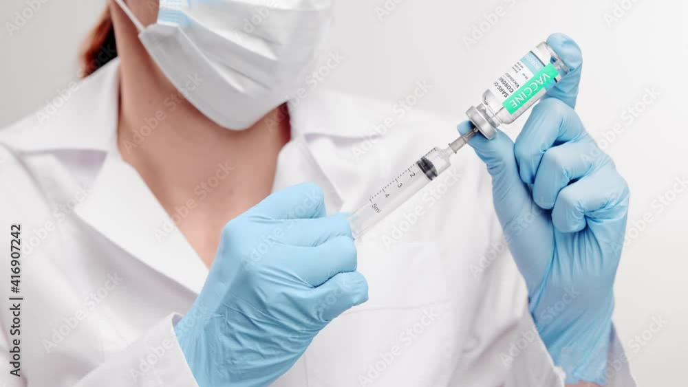 SARS - CoV2 Vaccination concept. Close up COVID-19 vaccine dose. A doctor or nurse in a laboratory holds a vial with a vaccine. Pandemic immunity. SARS - CoV2 Vaccination concept. Close up COVID-19 vaccine dose. A doctor or nurse in a laboratory holds a vial with a vaccine. Pandemic immunity.