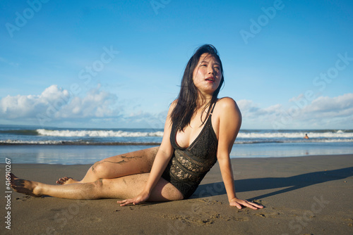beautiful Asian woman enjoying sand and sea - young happy and attractive Korean girl in bikini having fun at tropical beach during Summer holidays in travel and tourism concept © TheVisualsYouNeed