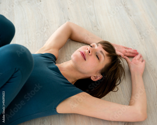 Woman is lying on the floor. Body therapy