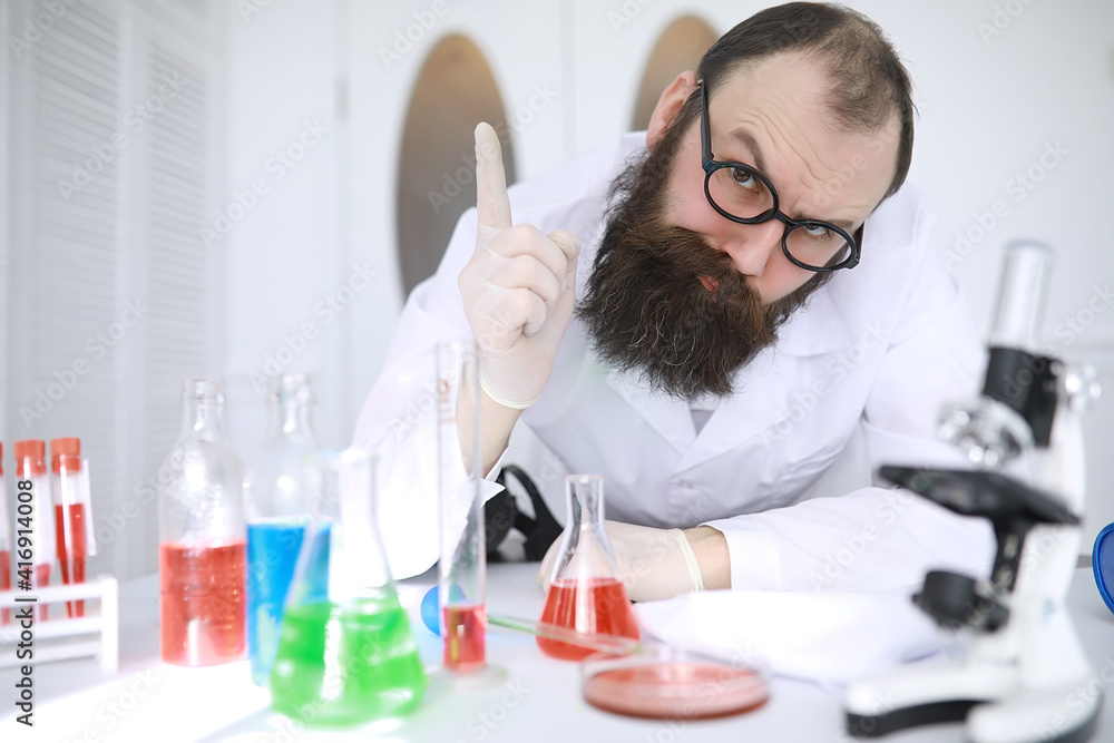 Chemist crazy. A mad scientist conducts experiments in a scientific laboratory. Performs research using a microscope. Chemist crazy. A mad scientist conducts experiments in a scientific laboratory. Performs research using a microscope.