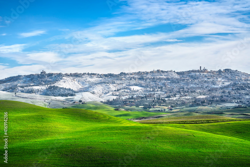 Volterra snowy town and rolling hills in winter. Tuscany, Italy