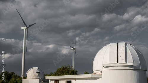 A telescope observatory dome and windmills photo