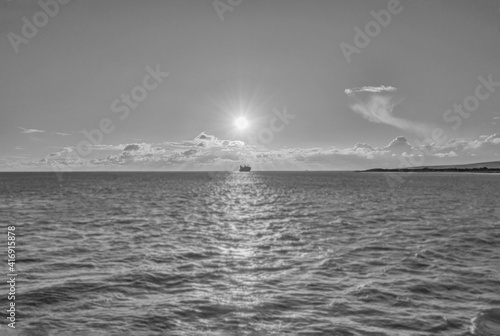 Fine Art Ship on the Horizon under the spotlight sun in black and white