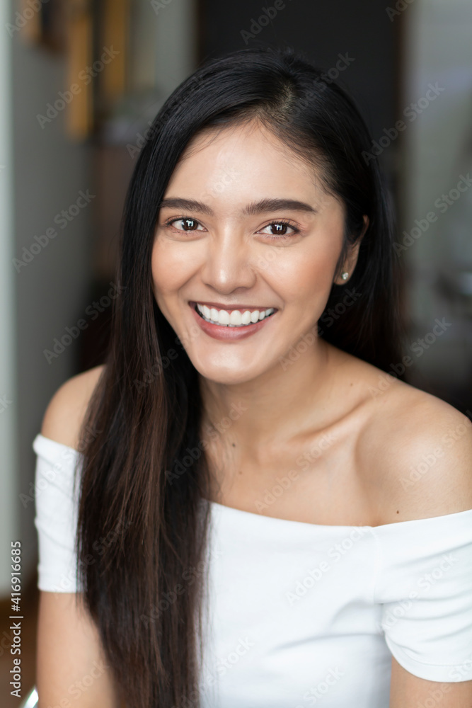 Young Asian teenage girl on white background. Casual Asian woman wearing white t-shirt posing to the camera at home. Portrait of casual Asian woman smiling indoor. Young Asian teenage girl on white background. Casual Asian woman wearing white t-shirt posing to the camera at home. Portrait of casual Asian woman smiling indoor.