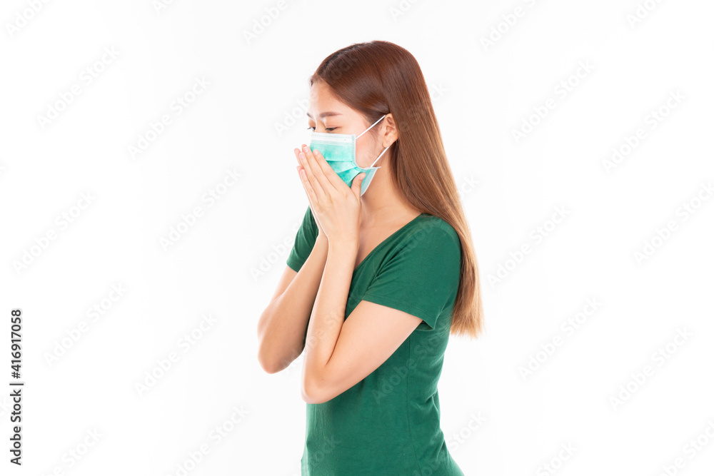 Young Asian teenage girl on white background. Casual Asian woman wearing surgical mask, corona virus (Covid-19) prevention. Casual Asian woman wearing green t-shirt over white background. Young Asian teenage girl on white background. Casual Asian woman wearing surgical mask, corona virus (Covid-19) prevention. Casual Asian woman wearing green t-shirt over white background.