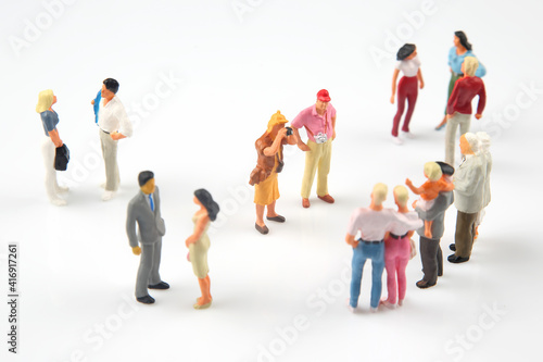 miniature people. different people communicate with each other on a white background