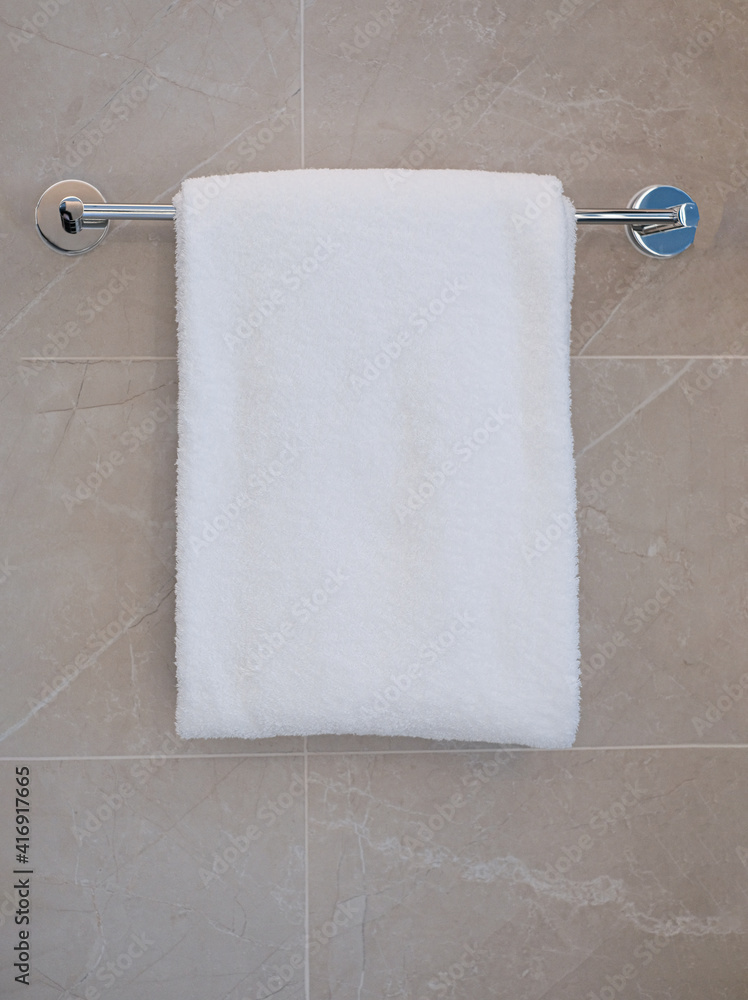 Bathroom bath towels hanging in bathroom. Towel napkin hanging on