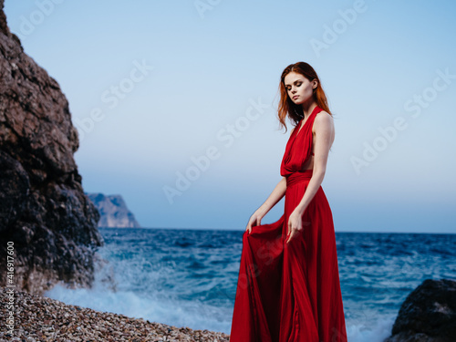 Attractive woman in red dress ocean island travel nature