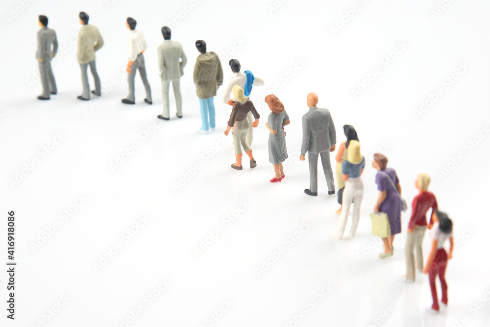 miniature people. different people stand in line one after another on a white background. communication of society of different generations miniature people. different people stand in line one after another on a white background. communication of society of different generations