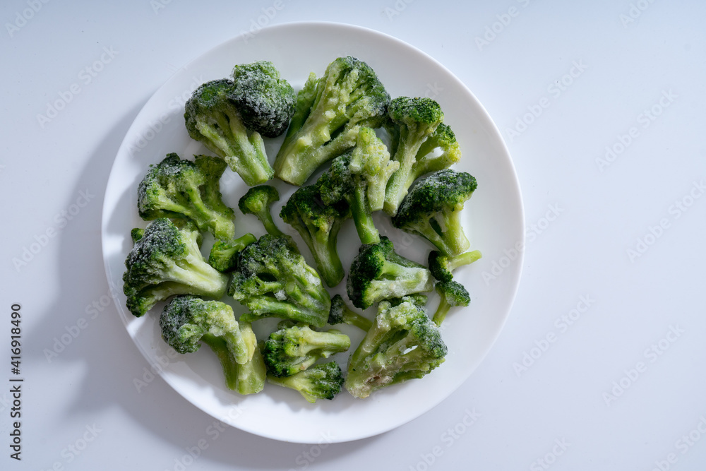 Frozen vegetables. Broccoli. White background Frozen vegetables. Broccoli. White background