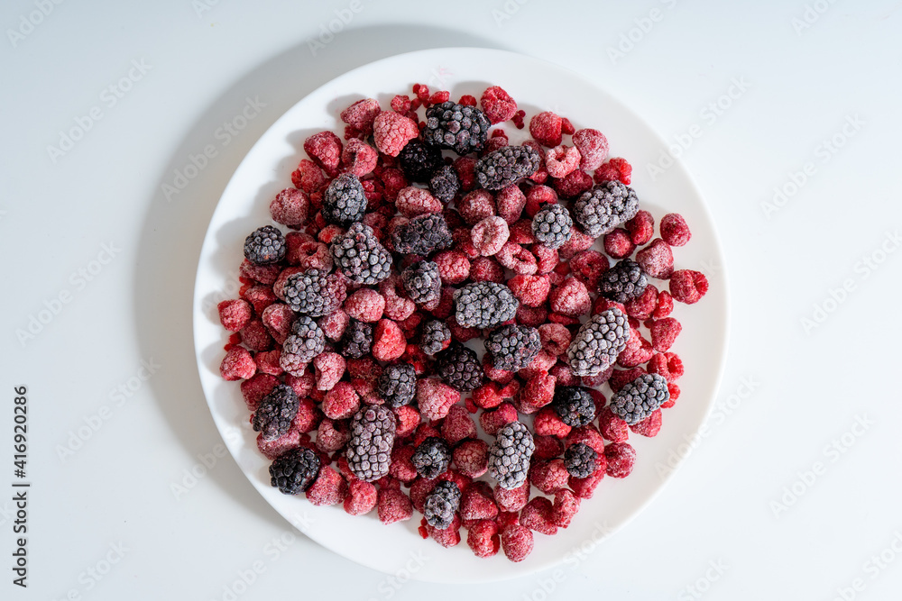 Raspberries and blackberries frozen, berries background. Selective focus Raspberries and blackberries frozen, berries background. Selective focus