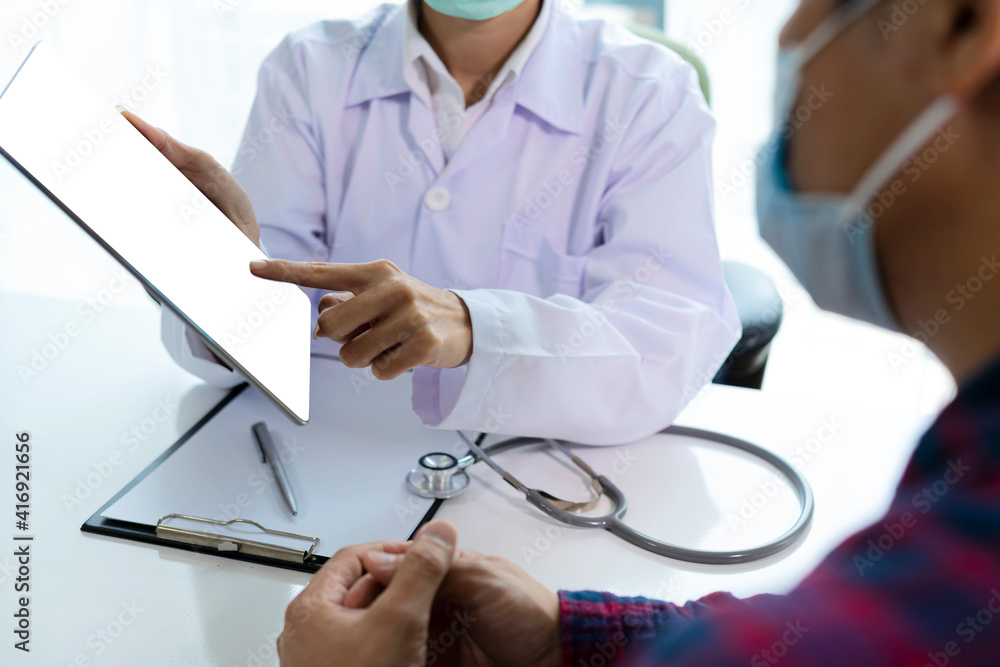 Woman doctor using tablet computer while. Doctor consultation with the patient by using digital tablet Woman doctor using tablet computer while. Doctor consultation with the patient by using digital tablet