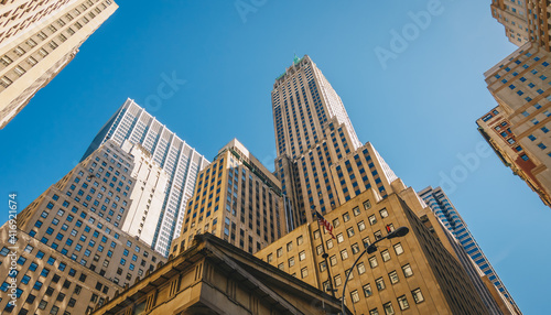 Giant skyscrapers dominate city streets of Wall Street. Lower Manhattan, New York City