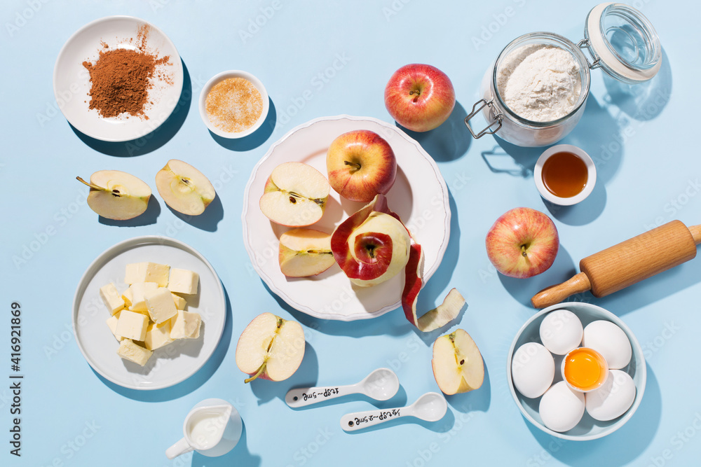 Cooking baking background with ingredients, fresh apples, spices and utensils on blue table. Cooking baking background with ingredients, fresh apples, spices and utensils on blue table.