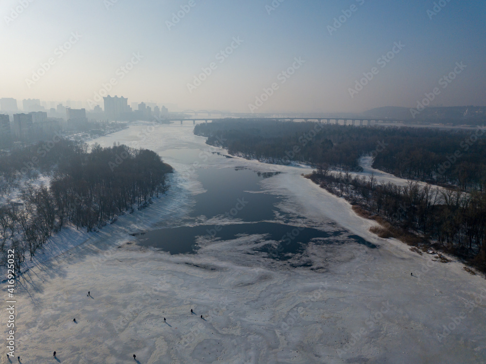 Melting Dnieper River in spring Kiev. Ice crack on the river. Aerial drone view. Spring sunny morning. Melting Dnieper River in spring Kiev. Ice crack on the river. Aerial drone view. Spring sunny morning.