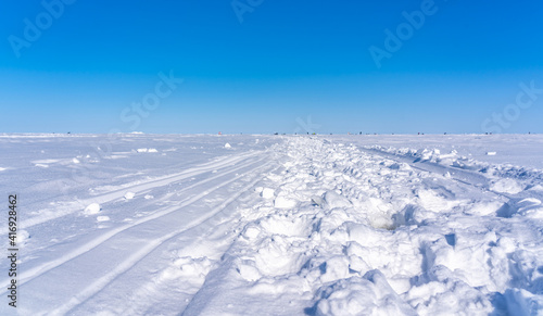 road on the frozen sea made by fishermen