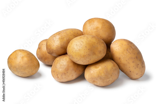 Heap of fresh raw Nicola potatoes isolated on white background photo
