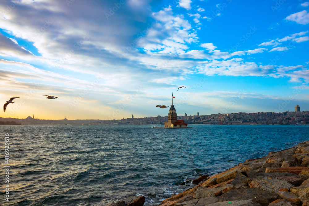 Maiden's Tower and Seagulls at sunset. Kiz Kulesi at sunset in Istanbul. Istanbul background photo. Travel to Istanbul. Sunset and cityscape of Istanbul.