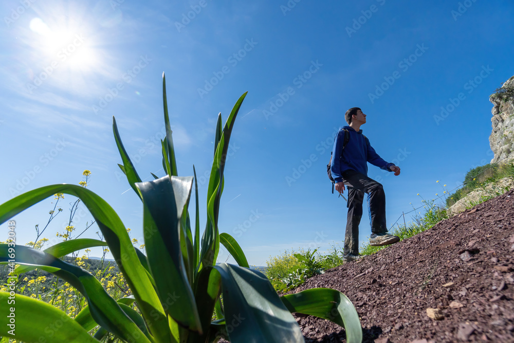 Active young boy wearing sportswear walking in the mountain during sunny day. Active young boy wearing sportswear walking in the mountain during sunny day.