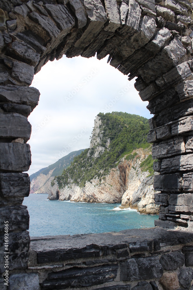 Ocean landscape and mountains through a natural stone window