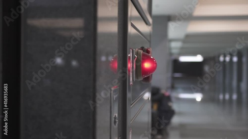 Close-up on fire fighting equipment in modern building. The lens shakes slightly. Truck shot from left to right. The subject is on the left.
