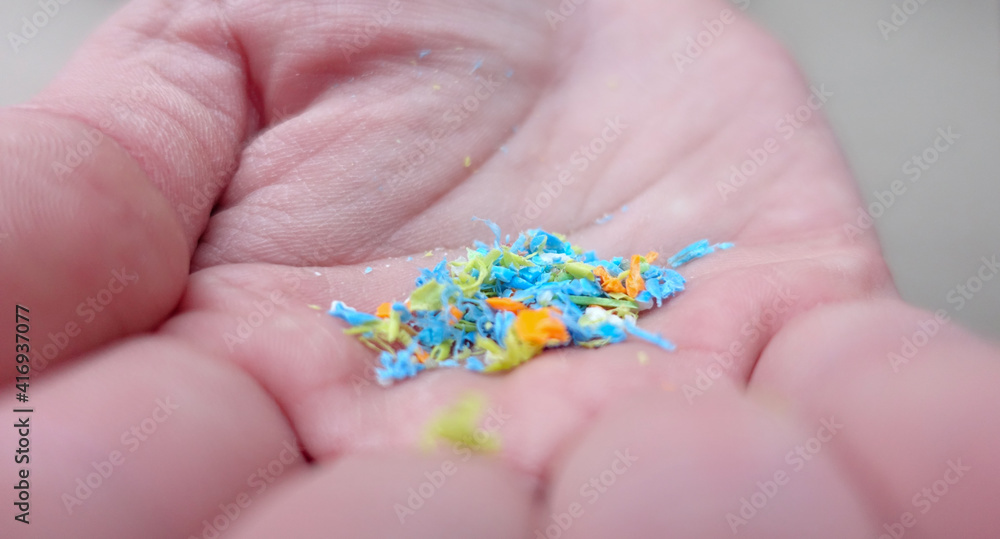 Side View Of a Person Holding Micro Plastics In His Hand. Non-Recyclable Materials. Selective Focus With Shallow Depth Of Field. Holding Microplastics From The Sand On The Beach. Side View Of a Person Holding Micro Plastics In His Hand. Non-Recyclable Materials. Selective Focus With Shallow Depth Of Field. Holding Microplastics From The Sand On The Beach.