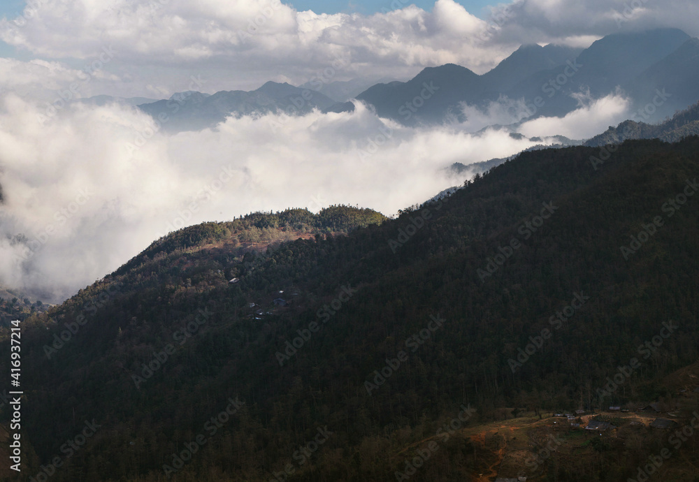 Forest mountains surrounded by clouds on a sunny day in Sapa in Vietnam