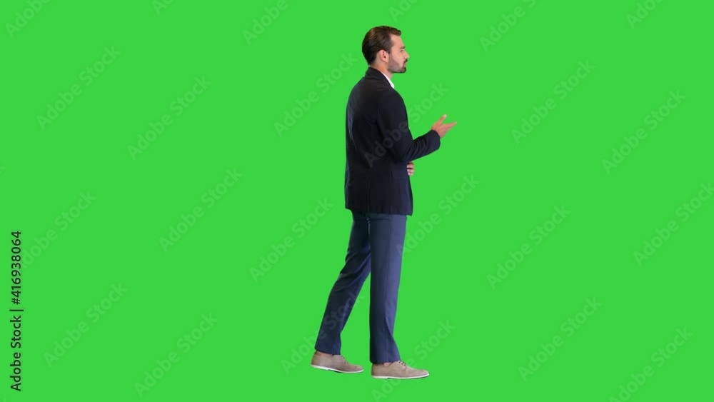 Young businessman in suit talking to camera on a Green Screen, Chroma Key. Young businessman in suit talking to camera on a Green Screen, Chroma Key.