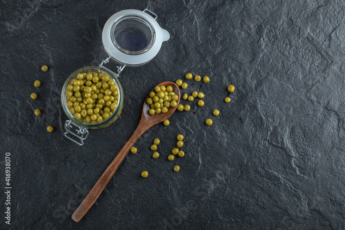 Green marinated olive in jar and ground Over black background