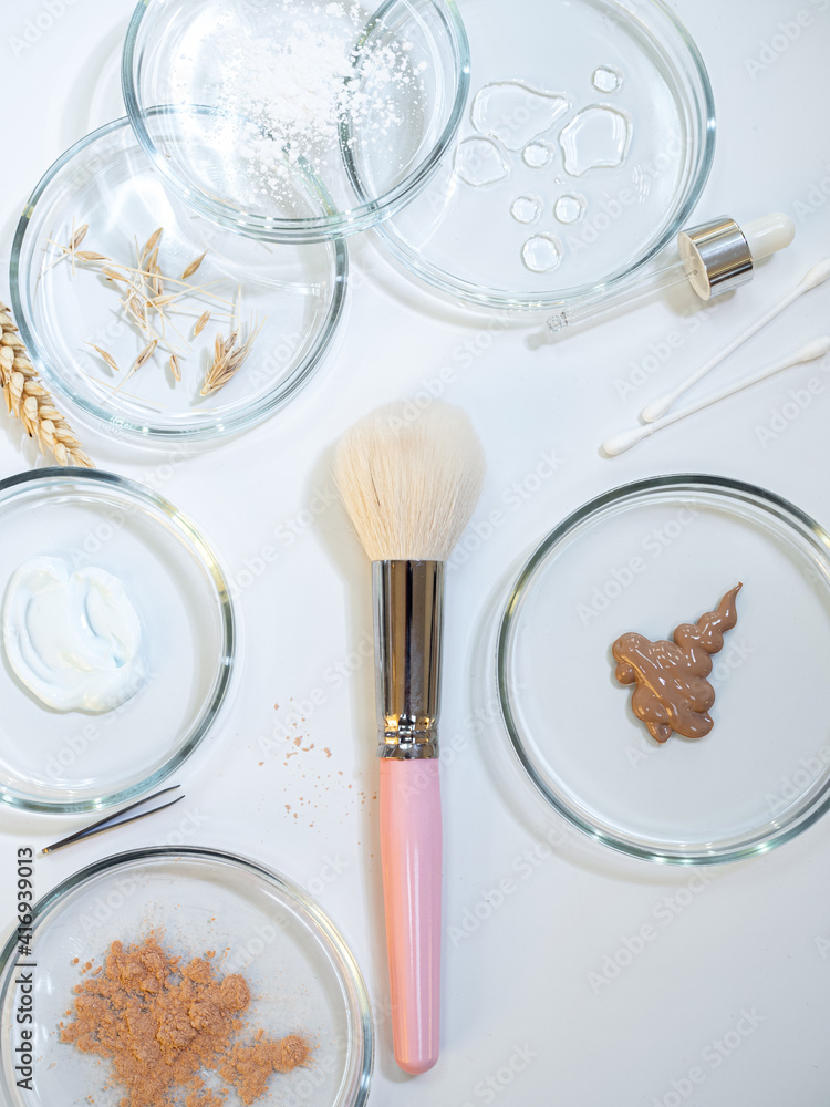 Eco-friendly and useful decorative cosmetics, concept. Powder and various ingredients in bottles Eco-friendly and useful decorative cosmetics, concept. Powder and various ingredients in bottles