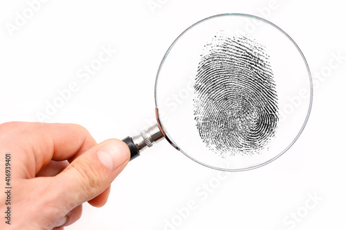 Magnifying glass in hand and fingerprint isolated on white background