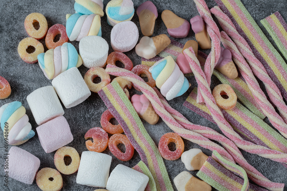 Mix of marshmallow and jellybeans on the marble background - obrazy, fototapety, plakaty 