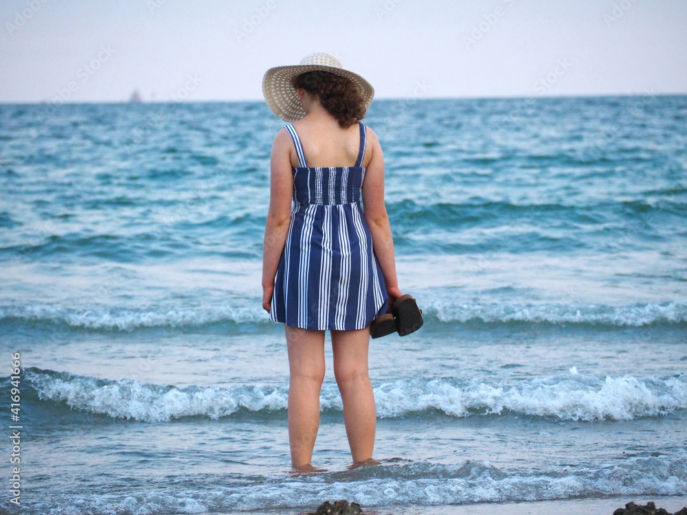 Beautiful woman with a hat at the beach Beautiful woman with a hat at the beach