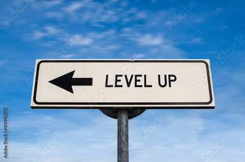 Level up road sign, arrow on blue sky background. One way blank road sign with copy space. Arrow on a pole pointing in one direction.