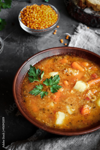 Soup with vegetables and red lentils. Vegan soup with beans and tomatoes.