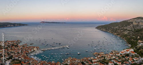 Aerial panorama drone shot of adriatic sea Komiza town on Vis Island in Croatia summer
