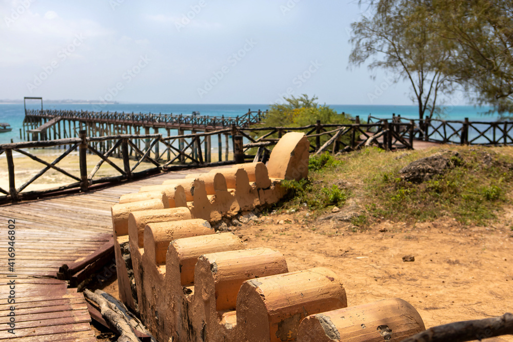 sunny day on turtle island in zanzibar. Hiking trail in the nature reserve. Unusual stone fence on the coast