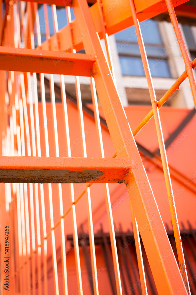 iron staircase in orange. industrial.