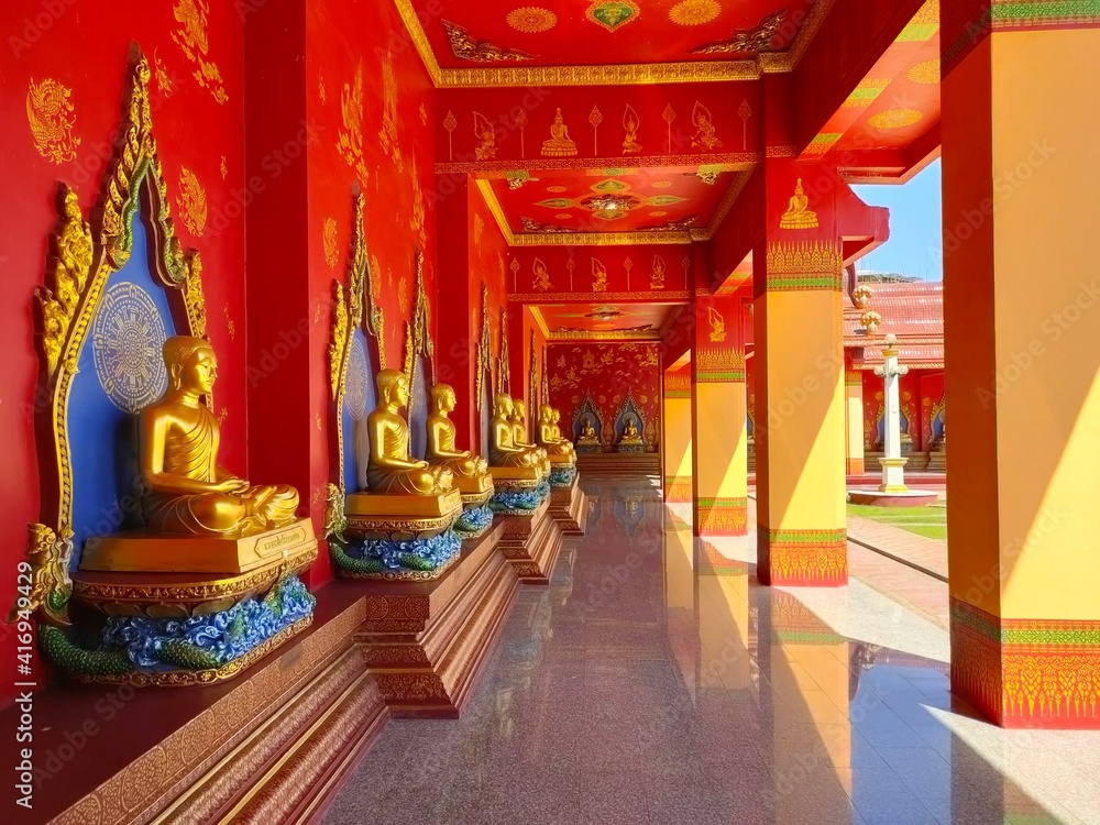 golden buddha statue and walkway in thailand